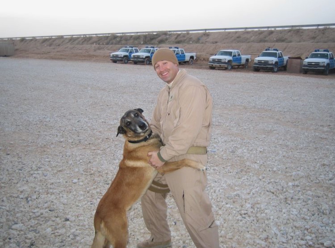 Matthew Crockett with a working dog in Iraq