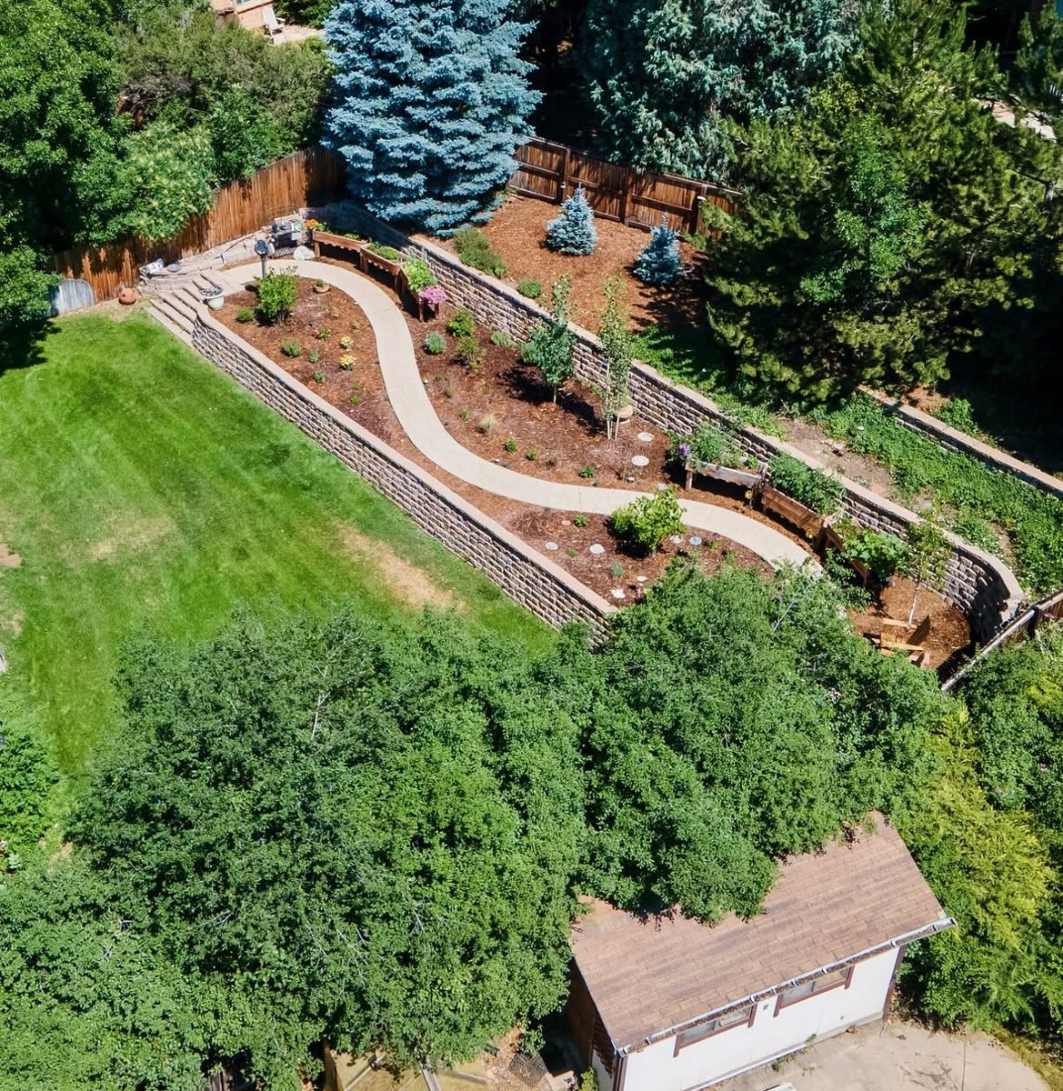 Tiered retaining walls and stone stairs on a hillside in Golden