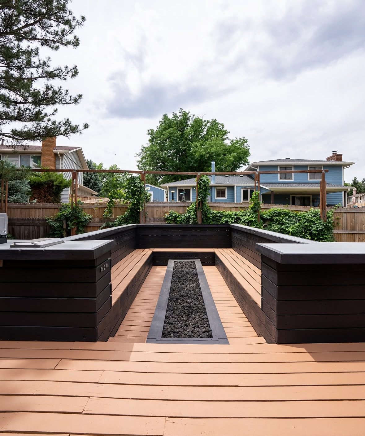 Custom outdoor entertaining deck with an integrated fire feature