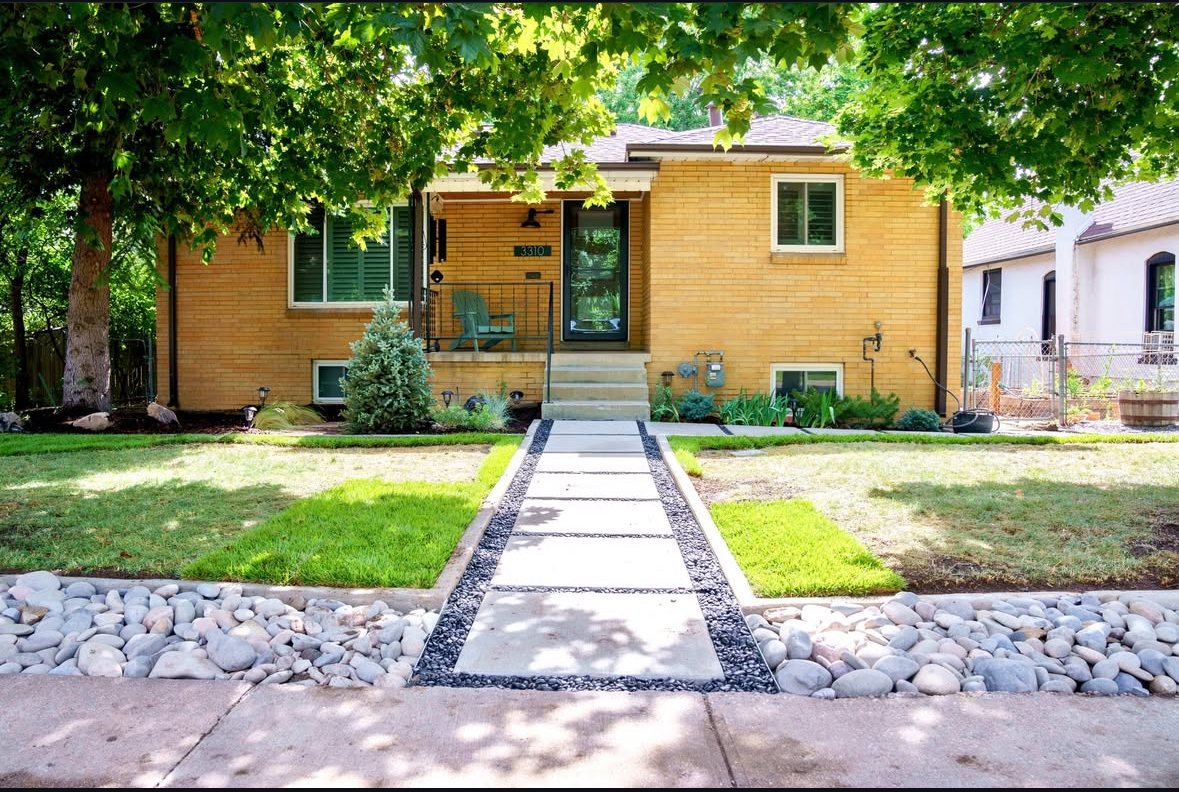 Residential entry landscape with lawn, river stone and a modern walkway